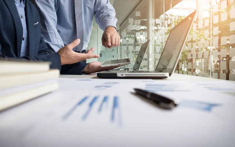 Retirement account statements and charts on a desk