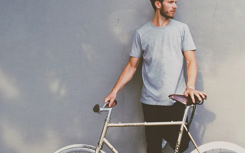 Man with a bicycle on a city street